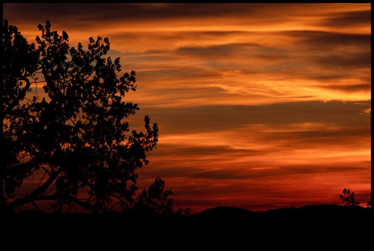 Sunset in badlands. Vivid colors are brought on by forrest fire smoke.